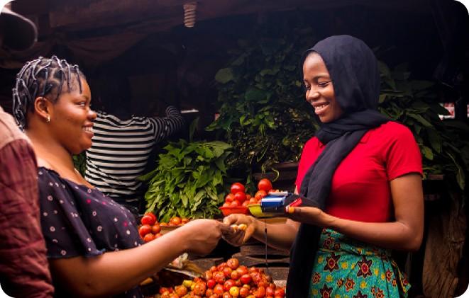A market trader taking a card payment on a POS terminal